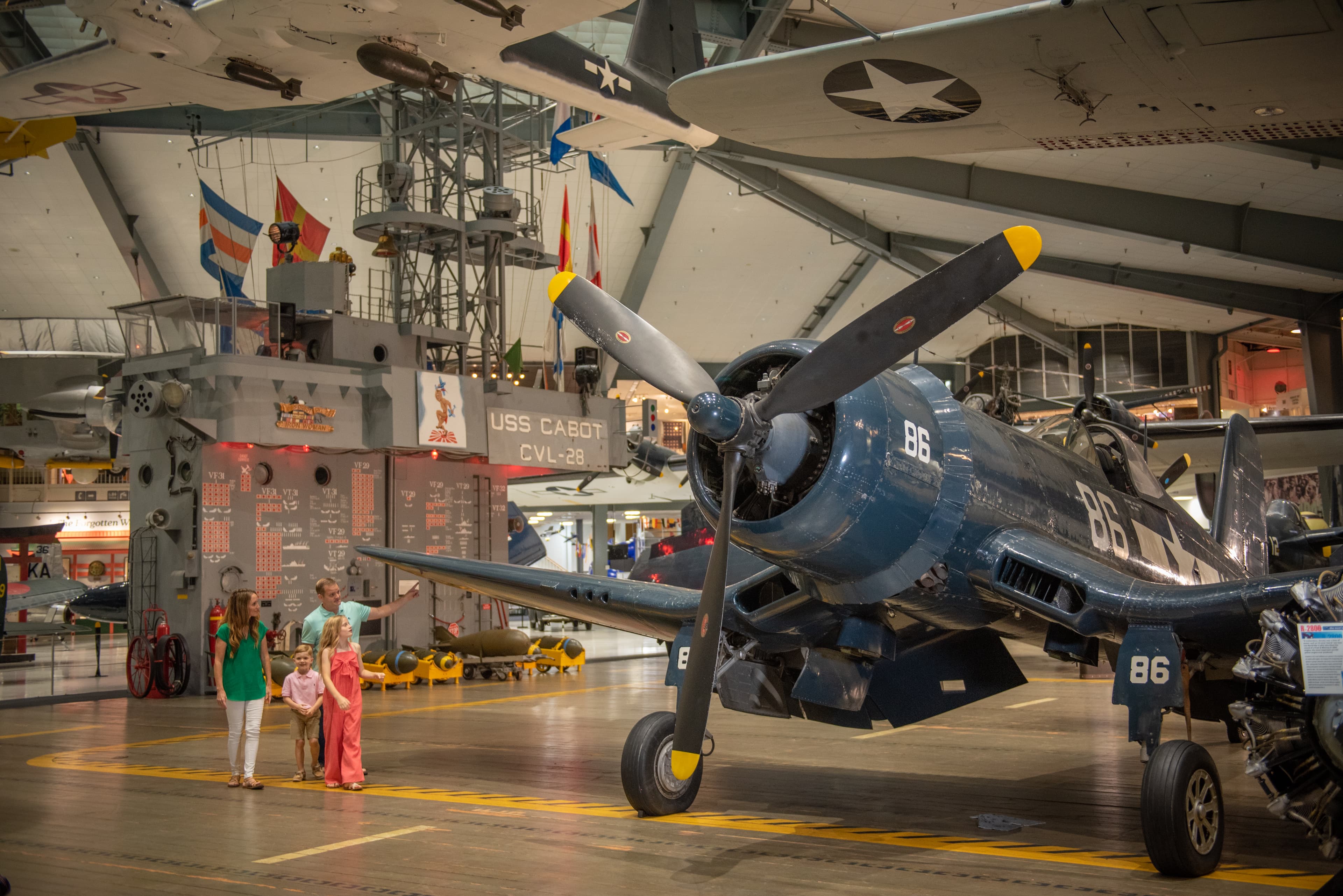 Family explores historic aircraft and the USS Cabot exhibit at the National Naval Aviation Museum, NAS Pensacola